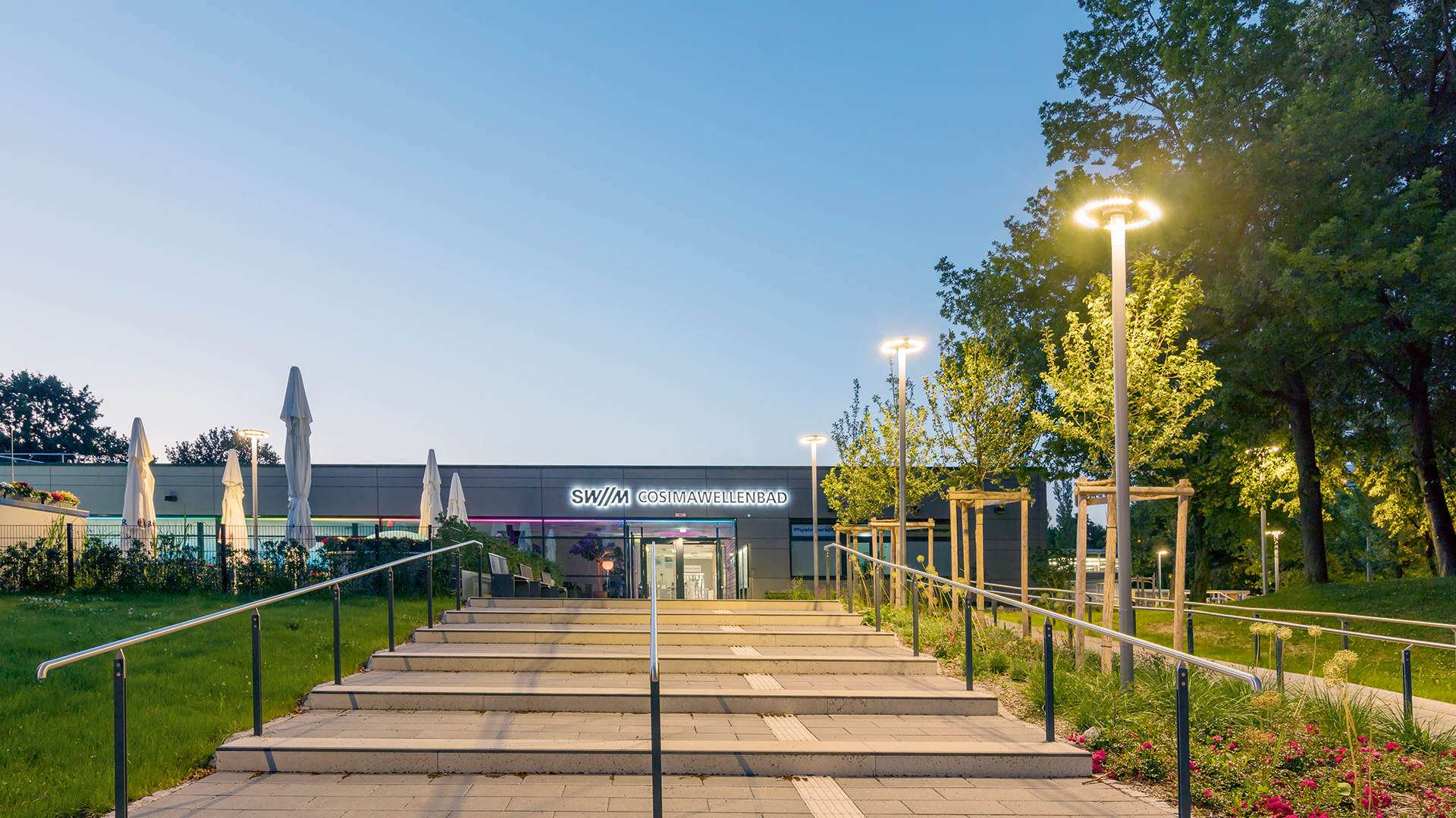 Option 1: "WE-EF CFT540 LED 36W luminaires with modern design illuminating entrance staircase and restaurant seating area at Cosimabad wave pool Munich Bogenhausen Germany