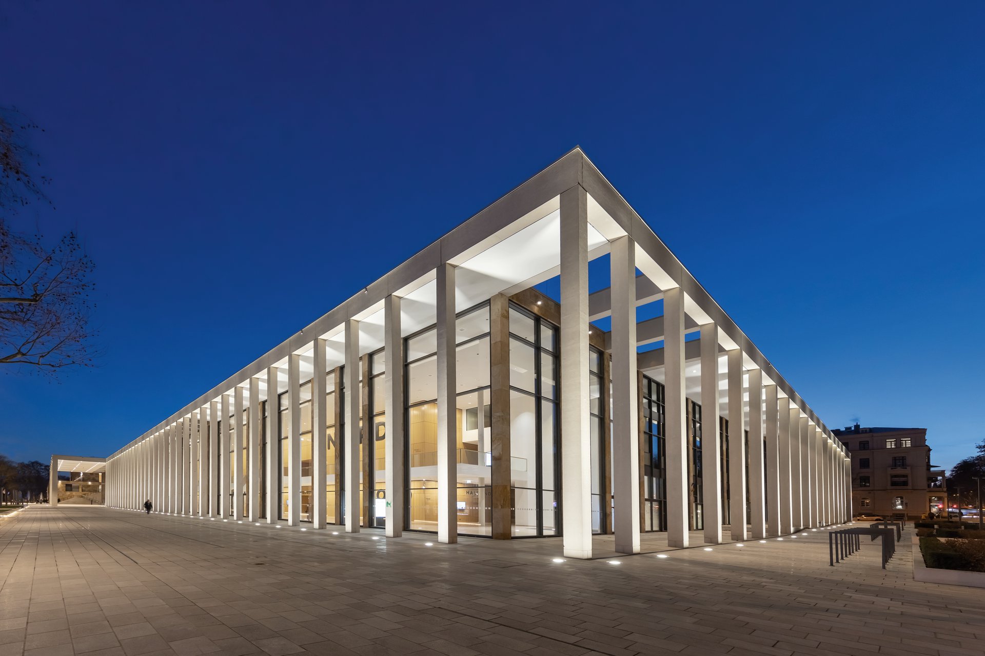 WE-EF ETC100 and ETC300 inground luminaires with 3000K warm white LED illuminating natural stone colonnade at DGNB platinum certified RheinMain CongressCenter Wiesbaden Germany