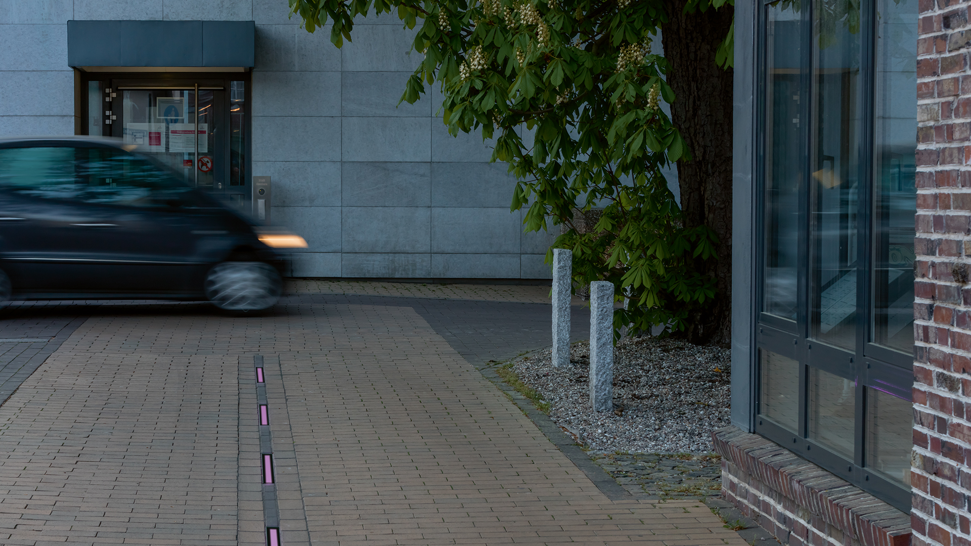 WE-EF ETV130 energy-efficient inground lighting integrated into pavement creating green orientation line in Elmshorn town center Schleswig-Holstein Germany
