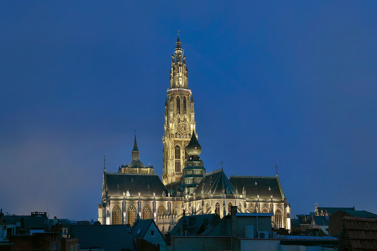 WE-EF FLC230 LED projectors illuminating Gothic Cathedral of Our Lady with ornamental tracery and towering spire at night in Antwerp Belgium