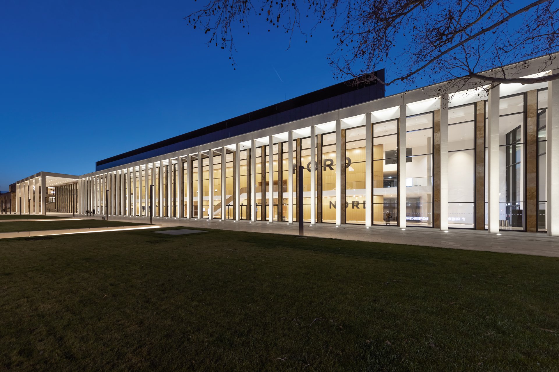 RheinMain CongressCenter entrance sign illuminated at night with WE-EF LED lighting showcasing modern congress center architecture in Wiesbaden Germany