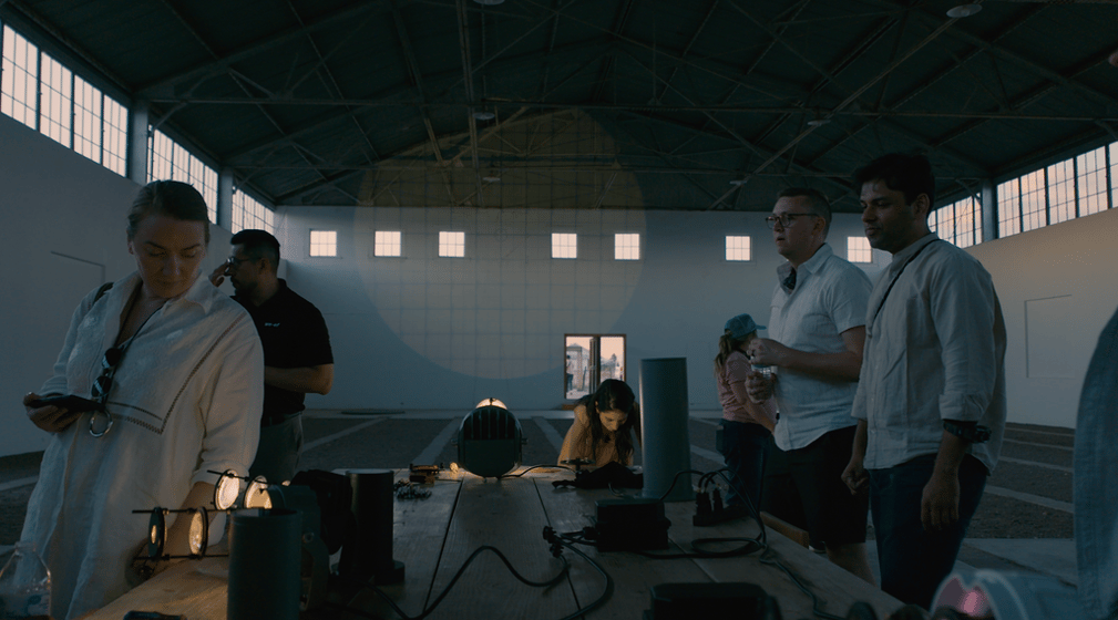 Lighting designers look at products in a darkly lit room